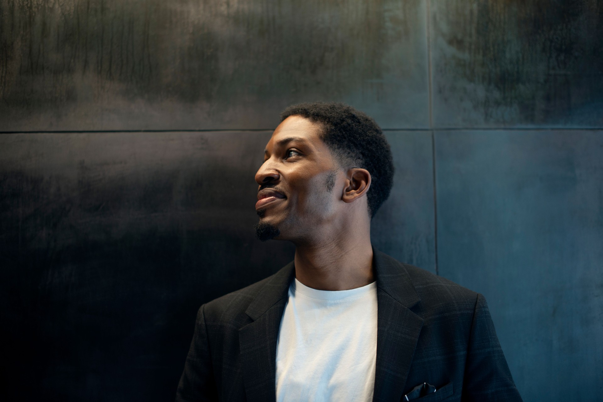 Thinking, business and African man with vision, planning or brainstorming startup idea on black wall background. Why, questions and male entrepreneur with career, mockup or problem solving solution
